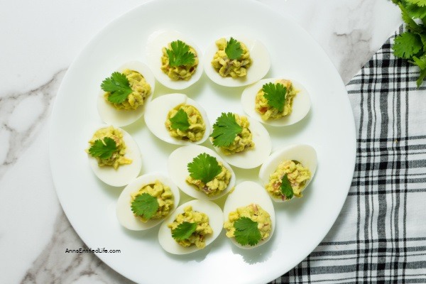 Avocado Deviled Eggs Recipe. These guacamole-inspired deviled eggs that are made with avocado, lime, tomato, and onion are simply delicious! Easy-to-make these avocado deviled eggs are a perfect party appetizer, great for picnics, tailgating, or for a snack for those on low-carb diets.
