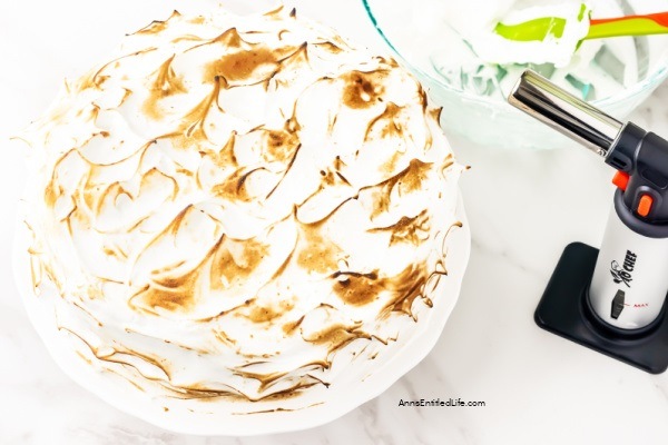 Lemon Meringue Cake Recipe. Layers of lemon cake filled with a lemon curd mixture and topped with a beautiful meringue frosting make for a spectacular presentation. If you like lemon, you will love this delicious lemon meringue cake.