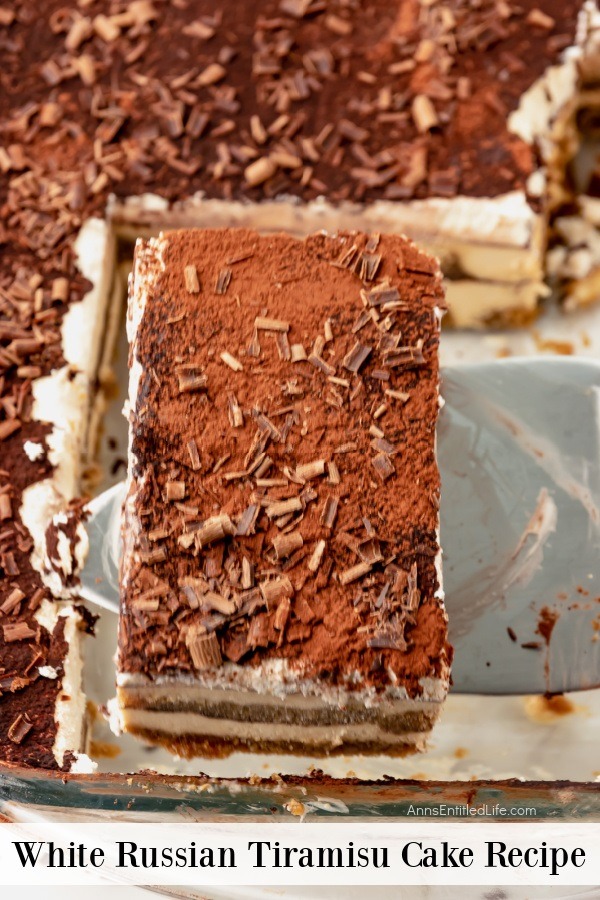 An up-close photo of a piece of white Russian tiramisu being lifted from the cake pan.