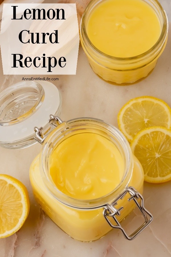 Overhead view of two open jars of lemon curd. Freshly sliced lemons are to the right and left of the bottom jar.