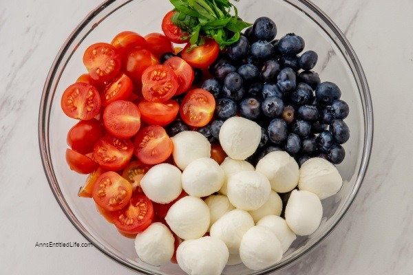 Red, White, and Blue Caprese Salad Recipe. Looking for a festive summertime Caprese salad recipe? Try this red, white, and blue Caprese salad. Made with fresh tomatoes, blueberries, and basil, this updated Caprese salad recipe is perfect for the 4th of July, summertime picnics, or a Memorial Day BBQ.