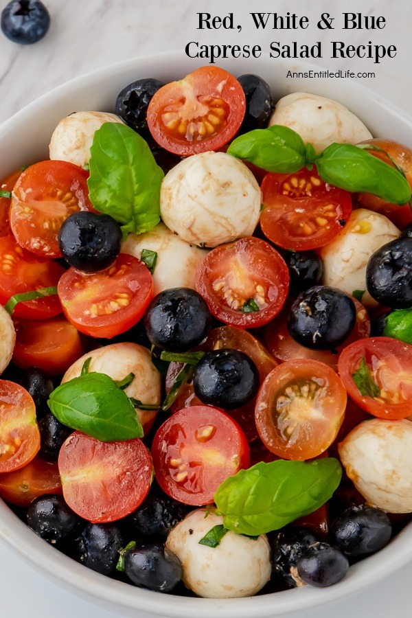 A closeup of the mozzarella, blueberries, basil, and balsamic glaze in a red, white, and blue Caprese salad