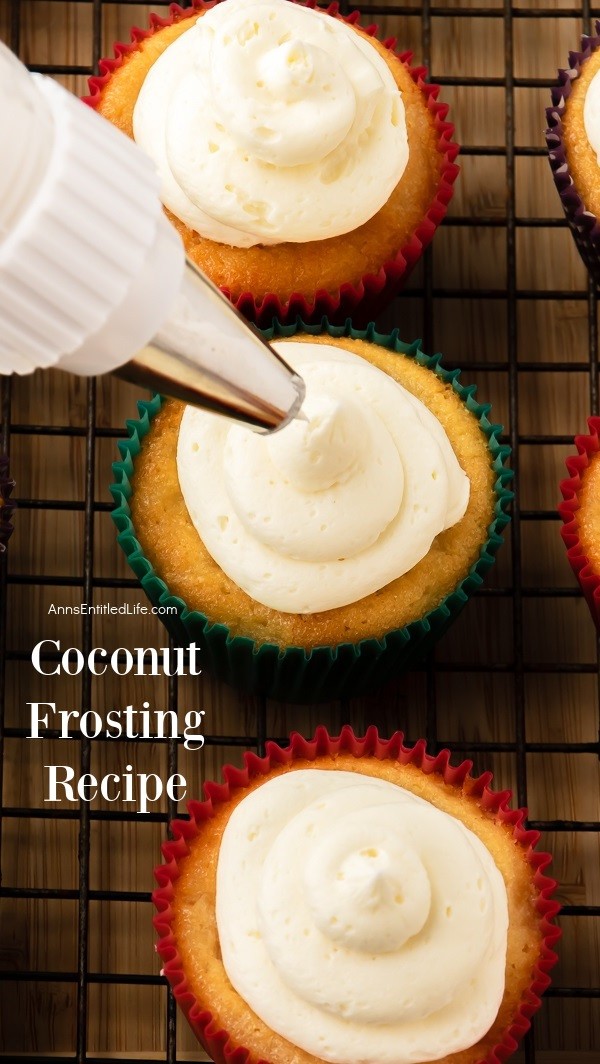 3 cupcakes on a baking rack being frosted with coconut frosting from a piping bag