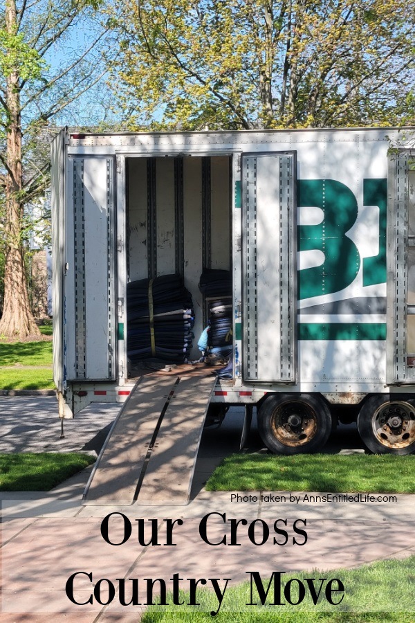 An open moving truck with loads of moving blankets inside, in a residential setting