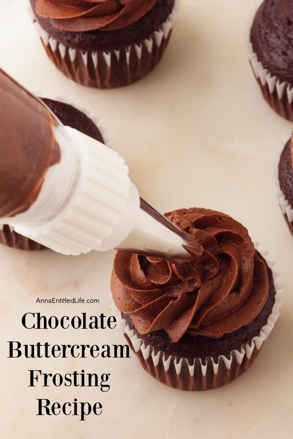 Chocolate buttercream frosting being piped onto the top of a chocolate cupcake