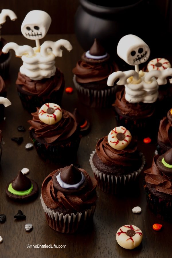 a variety of Halloween cupcakes against a dark background