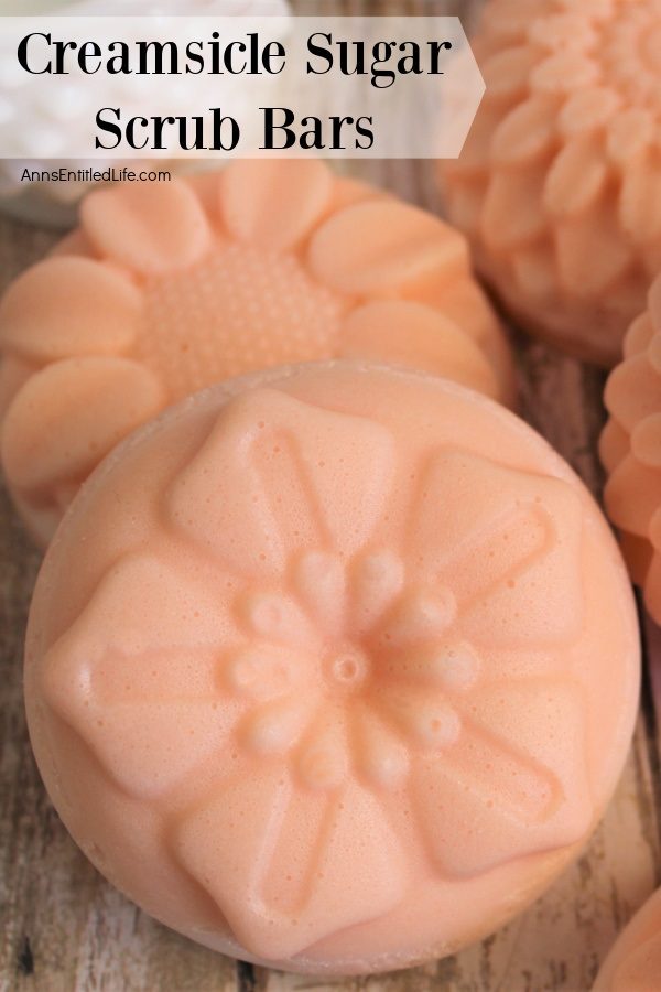 upclose image of 4 creamsicle sugar scrub bars on a wooden board.