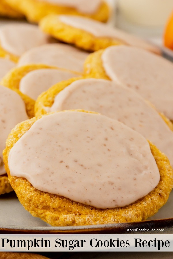 An up-close image of a white platter filled with pumpkin sugar cookies