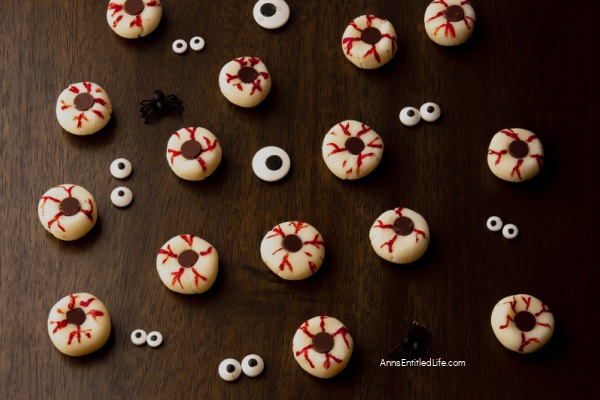 One  Halloween skeleton cupcake against a dark background