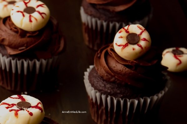 One  Halloween skeleton cupcake against a dark background