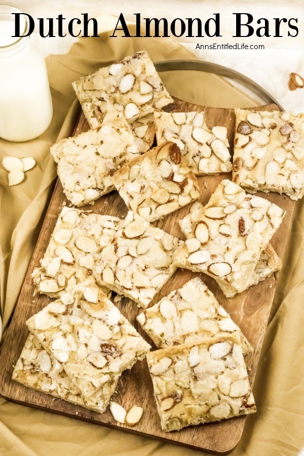 Overhead view of cut Dutch almond bars on a wooden cutting board, a small jug of milk is in the upper left