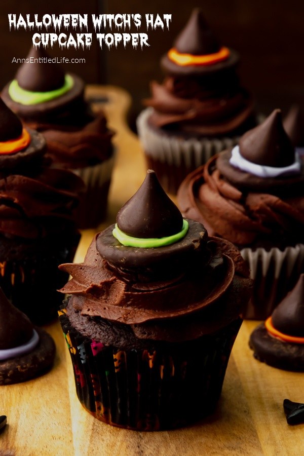 Six Halloween witch's hat topper cupcakes on a butcher block