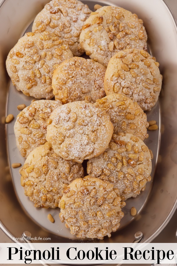 Overhead image of a white platter filled with pignoli cookies