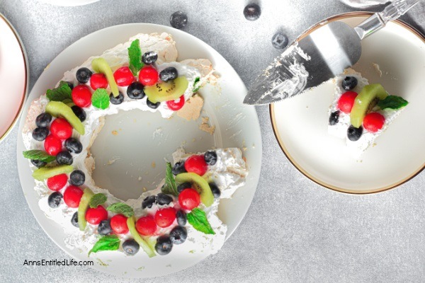 Christmas Pavlova Recipe. Pavlova is a meringue-based dessert with a crispy top and a soft, marshmallow-like center. This Christmas pavlova is topped with a generous amount of sweet vanilla whipped cream and sliced fruits and berries, which makes this classic dessert absolutely delectable. This wreath-shaped pavlova is perfect for Christmas day and is a real crowd-pleaser.