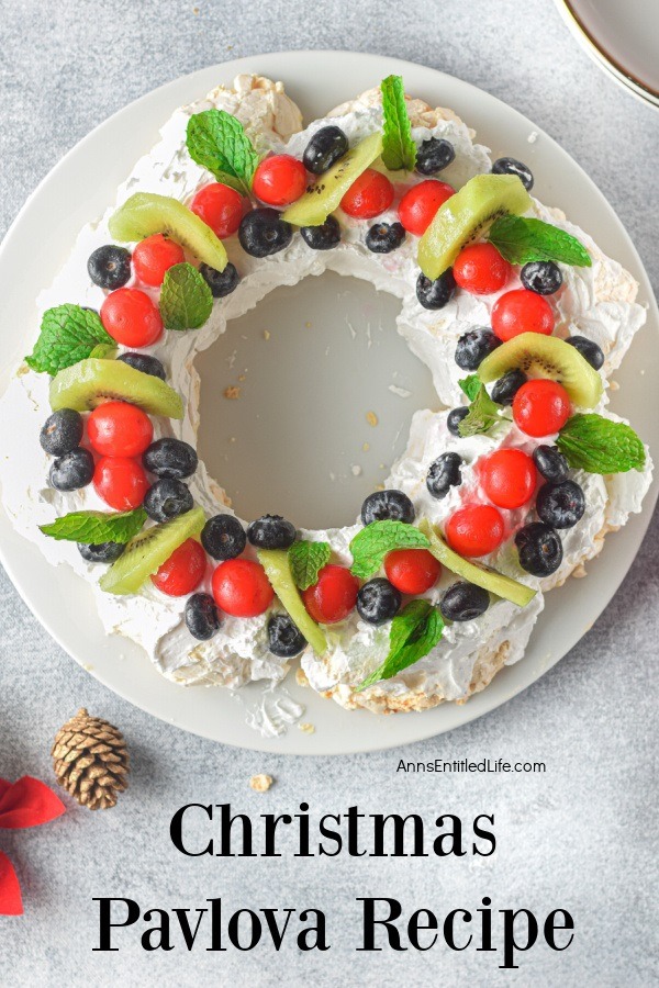 Overhead view of a Christmas pavlova wreath on a white cake stand