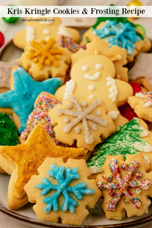 A plate filled with frosted and decorated Kris Kringle cookies