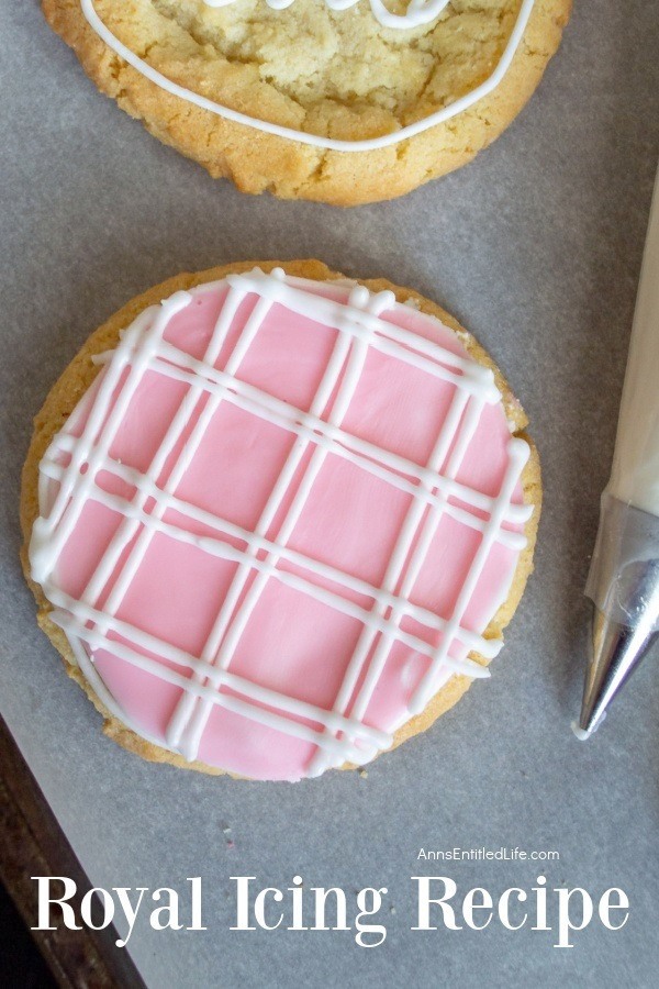 Up close image of a cookie decorated with royal icing, the pastry bag filled with icing is partially seen on the right