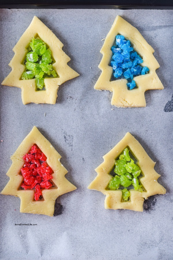 Stained Glass Cookies Recipe. Delicious and crisp sugar cookies are cut into shapes and filled with hard candies, which give a beautiful stained-glass effect after they are baked. These cookies are easy to make and look gorgeous. A delightful, simple, and mouthwatering treat to add to your Christmas cookies list.