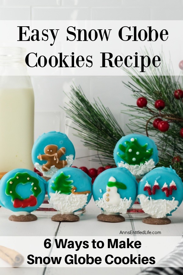 Six assorted snow globe cookies standing on a whiteboard, Christmas decor surrounds the cookies
