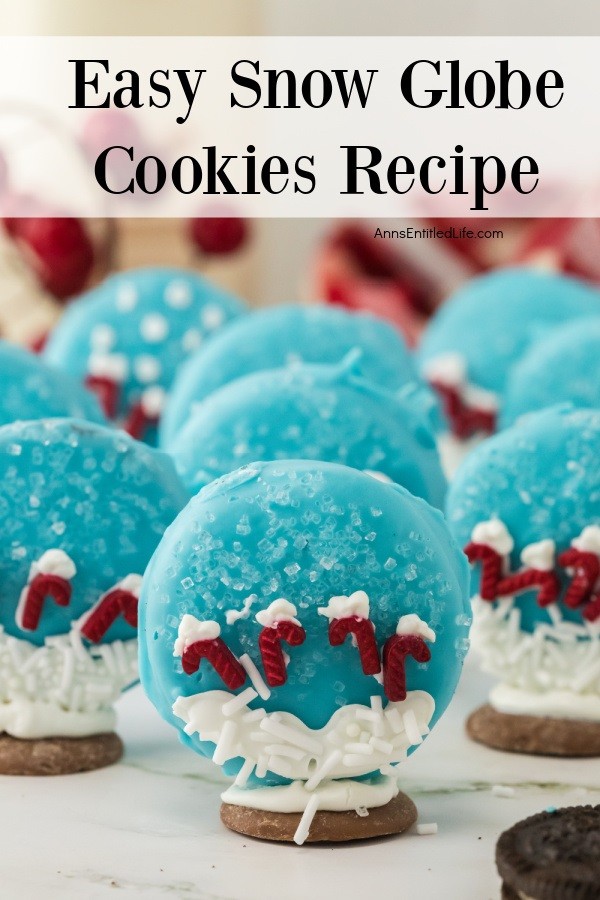 Nine candy cane snow globe cookies standing on a white surface