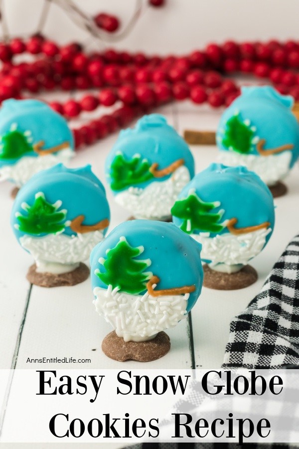 Six sleigh snow globe cookies standing on a wooden surface