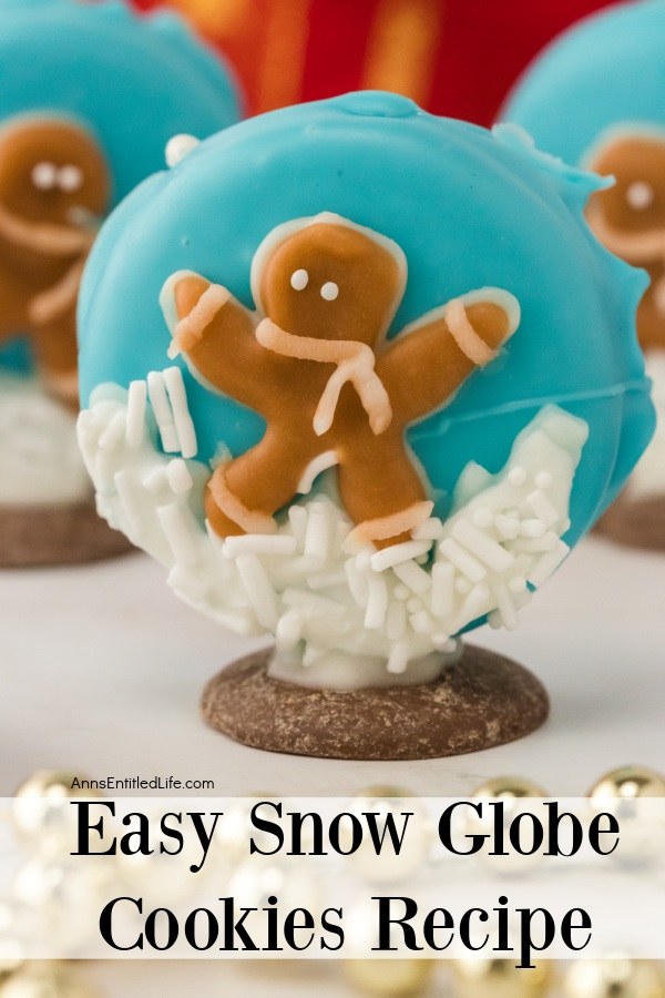 A snow globe gingerbread man cookie standing on a white surface