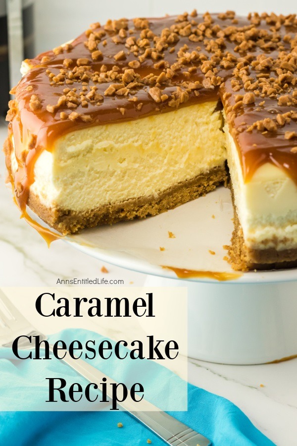 A side view of a caramel cheesecake on a white cake plate with one piece missing.
