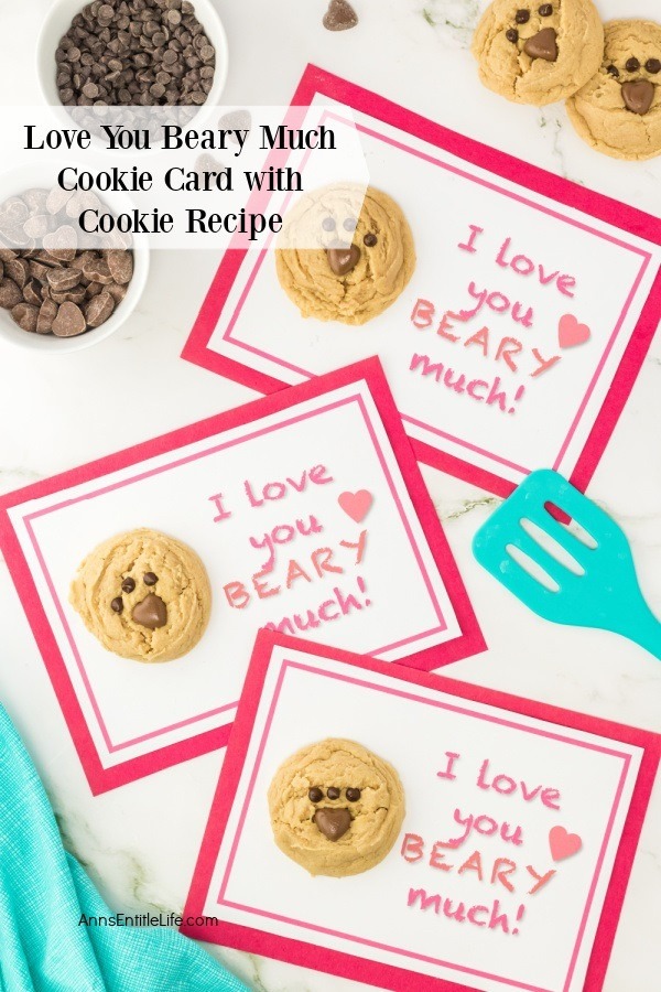 3 Love you beary much cookie cards surrounded by chocolate chips, more cookies, and a blue spatula