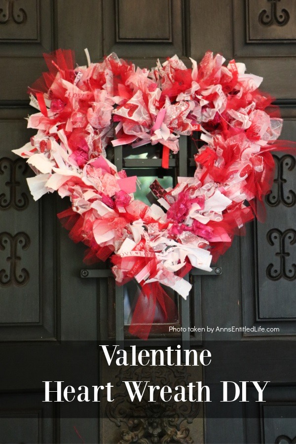 a heart shaped red, white, and pink Valentine's day wreath hanging on a front door