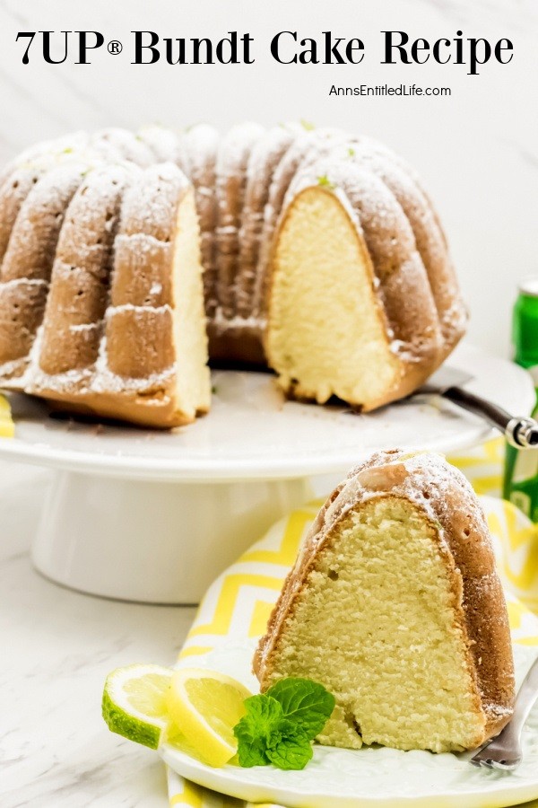 7UP Bundt cake on a white cake dish atop yellow and white chevron linen. There is a piece of the cake cut on a white plate in the front.