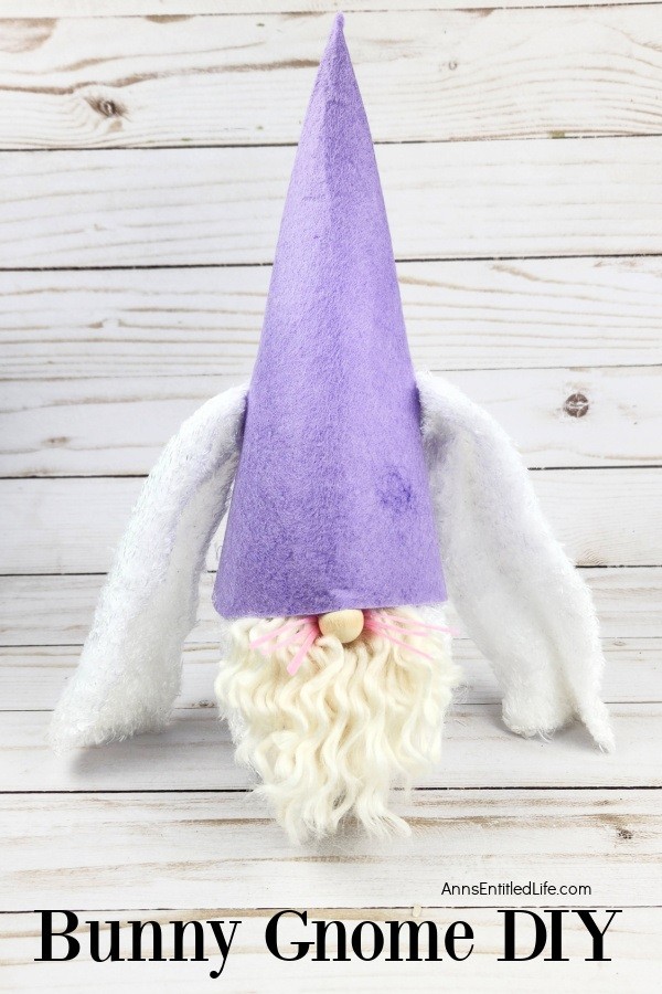 a homemade bunny gnome against a grey background