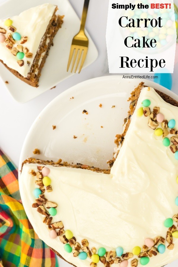 An overhead view of a piece of carrot cake on a white plate, the rest of the cake is on a white cake platter