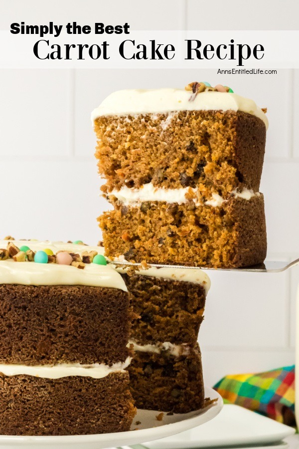 A piece of carrot cake being lifted on a cake server from a carrot cake on a white cake stand