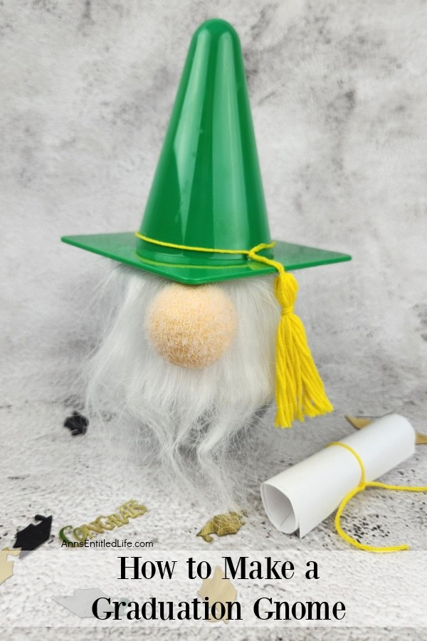 a homemade garden gnome on a marble top, a small diploma sits to the right along with graduation confetti