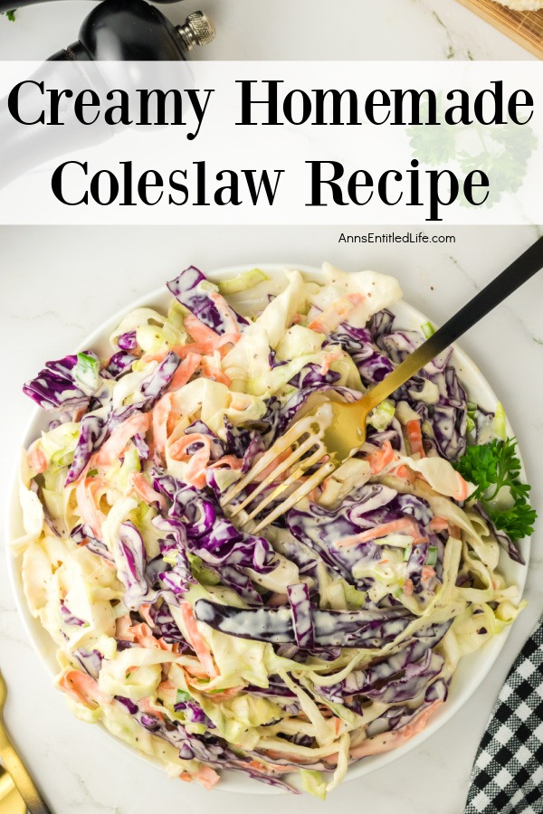  overhead image of a white bowl filled with homemade coleslaw, there is a fork on top of the coleslaw