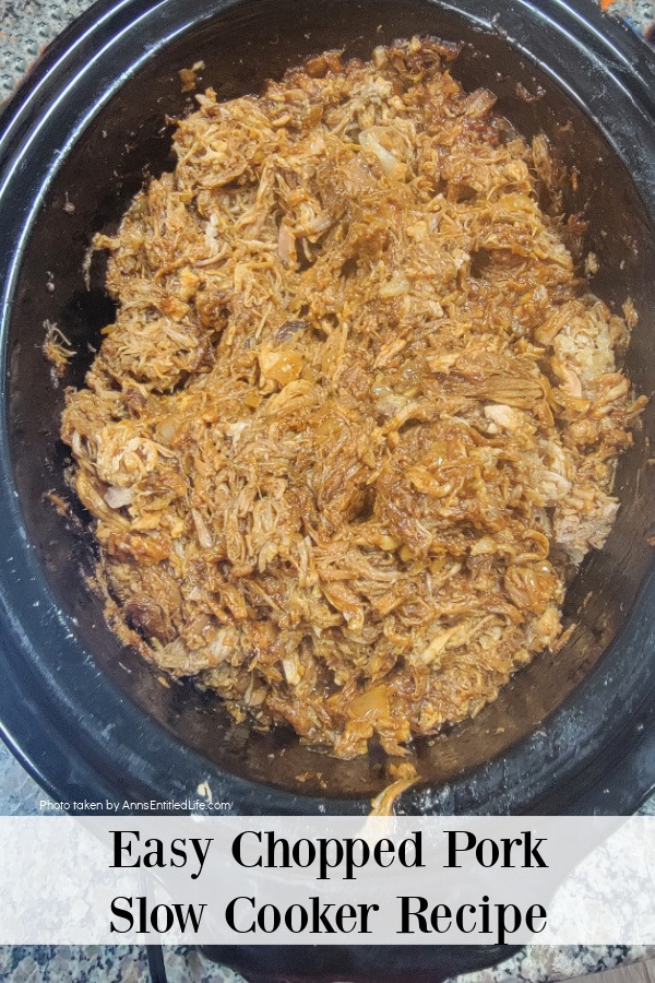 overhead image of a slow cooker pot filled with cooked copped pork