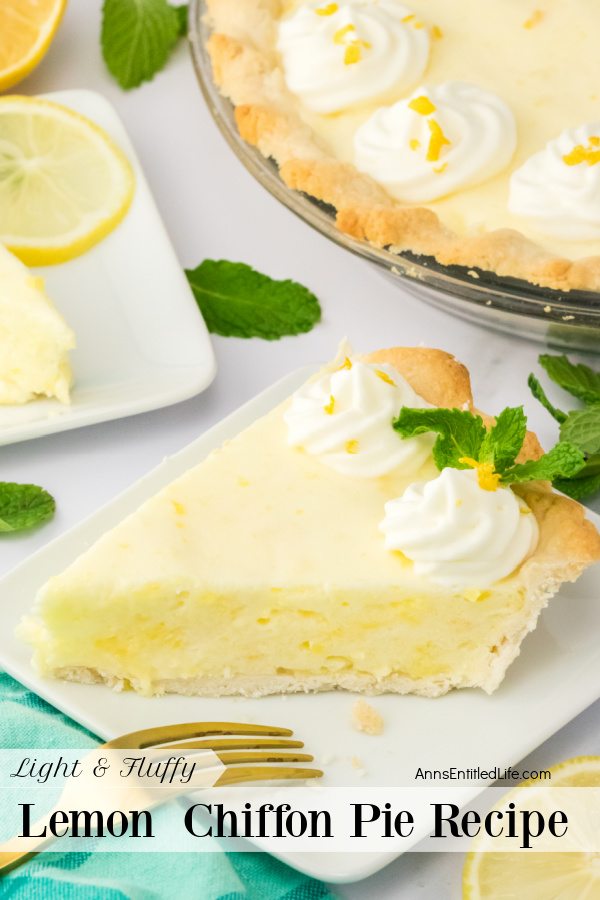 A slice of pie sits on a white plate with a gold fork resting on the plate. The remaining pie is in the upper right, and a second piece of cut pie is barely seen in the upper left. A sliced lemon is in the lower right, a green checked napkin in the lower left.