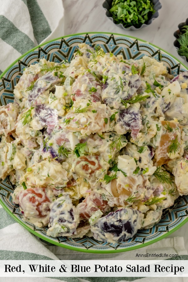 overhead image of a festive bowl filled with red, white, and blue potato salad