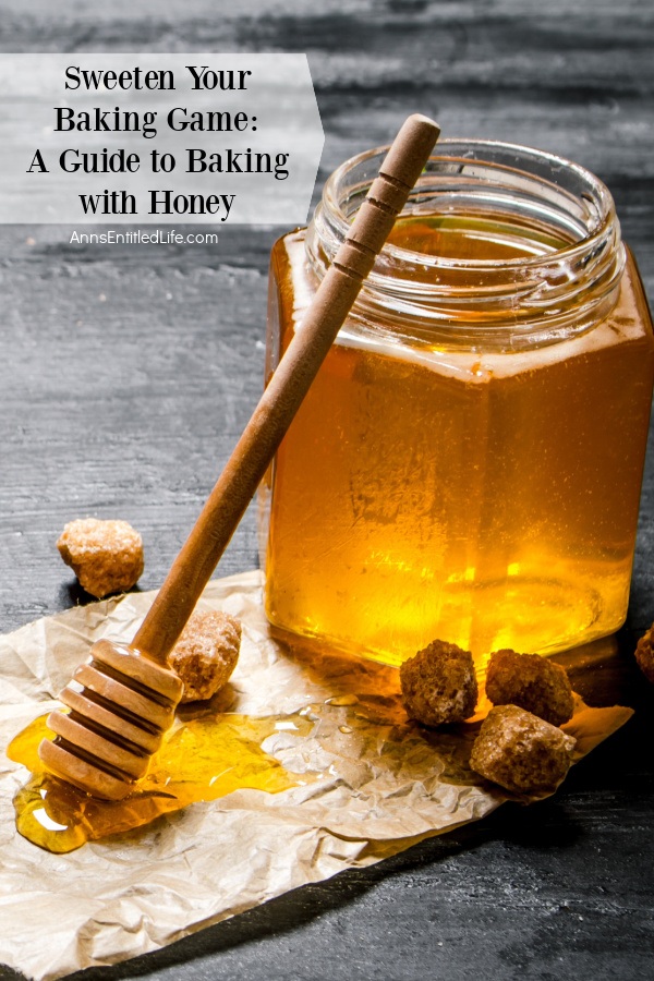 A jar of honey sitting on a brown paper. There is a honeycomb stick, the head sitting in a pool of honey, propped against the jar of honey.