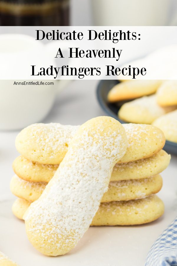 A stack of four ladyfingers on a white board, another ladyfinger is stacked in from. A blue plate filled with ladyfingers is in the upper right.