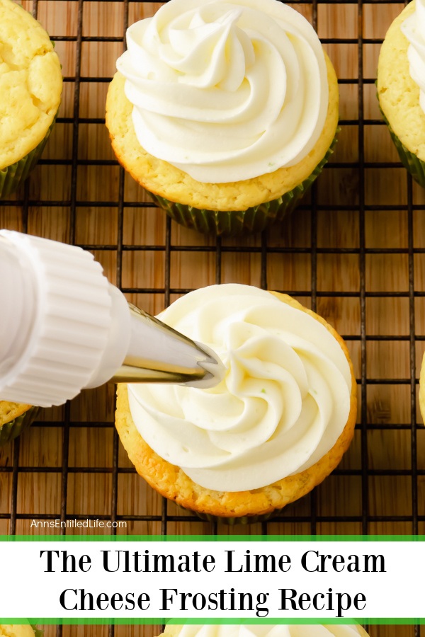 Lime cream cheese frosting in a piping bag being piped onto a cupcake on a wire rack