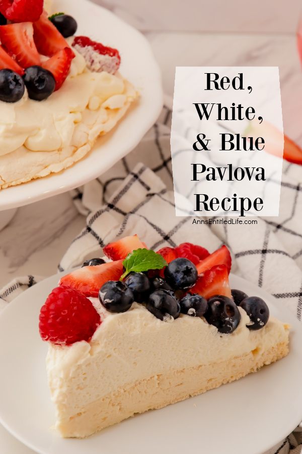 a slice of red, white, and blue pavlova on a white plate, the rest of the dessert is in the upper left, a white and black checked napkin is in the upper right