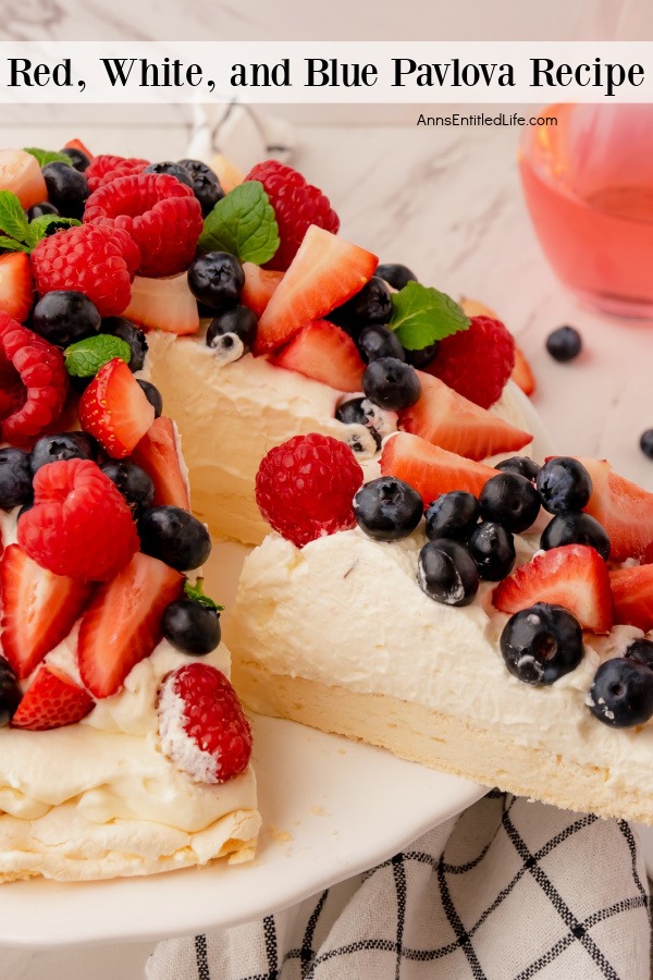 a slice of red, white, and blue pavlova is being removed from the whole dessert