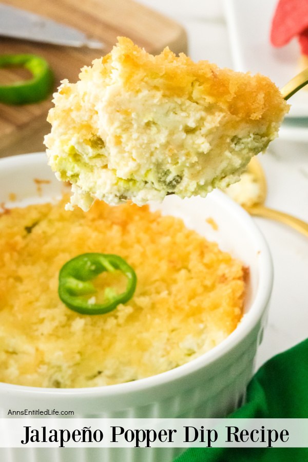 A spoonful of jalapeno popper dip is being removed from the ramekin filled with jalapeno popper dip below