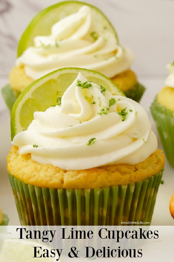 Close-up of a frosted and decorated lime cupcake in a green wrapper, a second cupcake is directly behind the first one