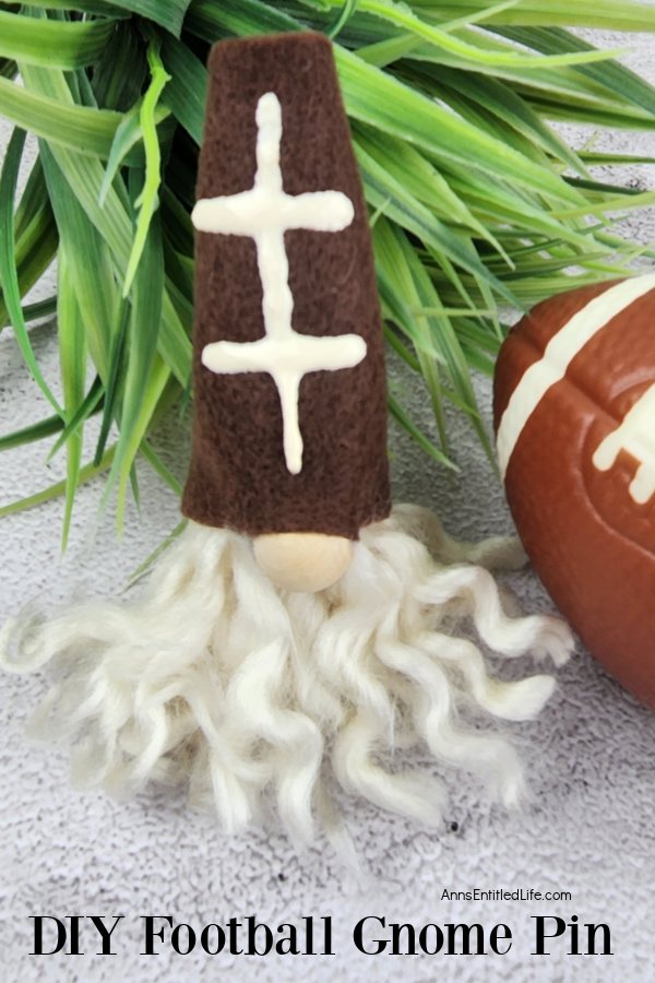 A homemade football gnome pin against a backdrop of green and a small football