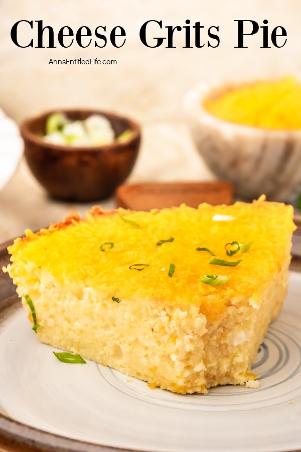 an up close view of a piece of cheesy grits on a plate. There is green onions and shredded cheese above it.