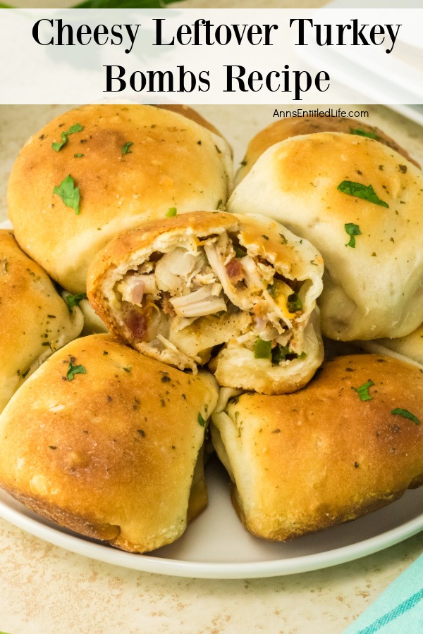 a plate piled with cheesy turkey bombs, the top one is open to show the filling inside