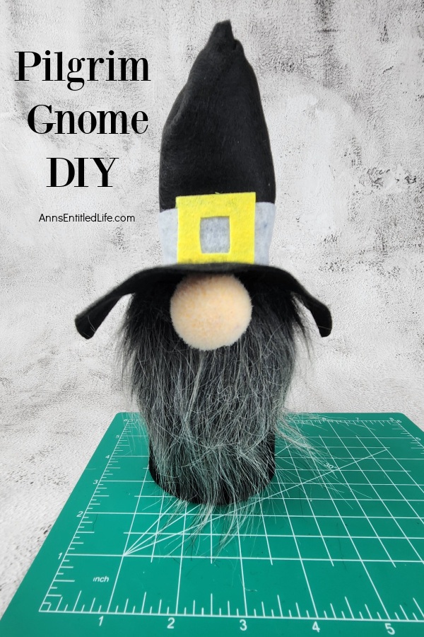 Homemade gnome pilgrim set atop a cutting mat