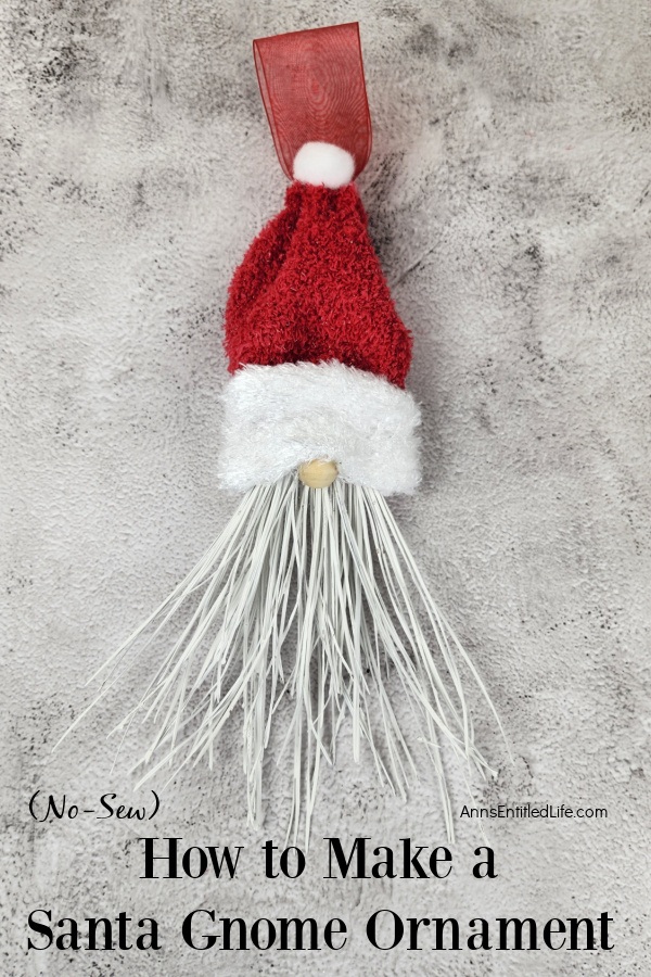 Homemade Santa gnome ornament set against a grey background